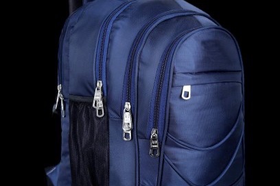 Navy backpack on a black background.