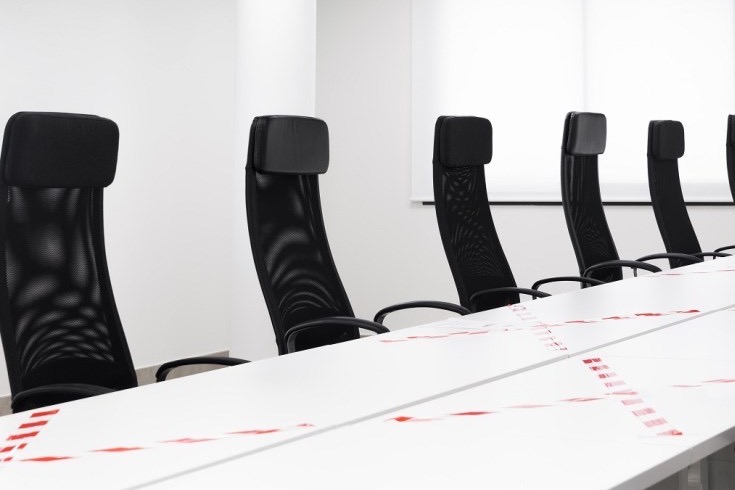 Boardroom fitted with black mesh high-back chairs.