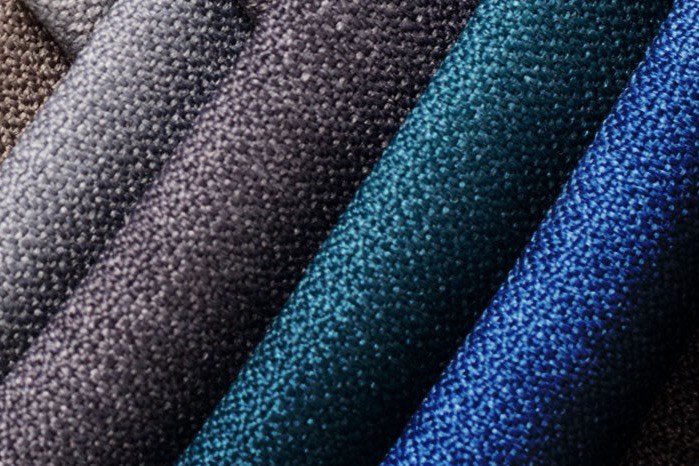 Fabric folds running from grey through teal to blue.